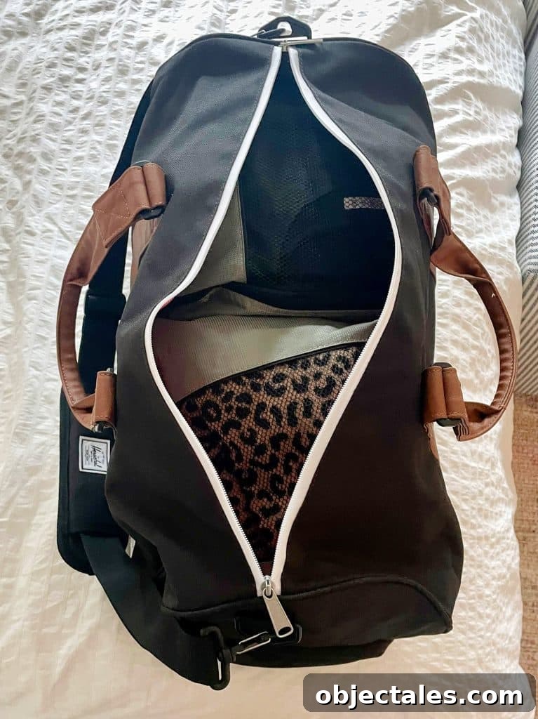 Overnight duffel bag packed with packing cubes on bed