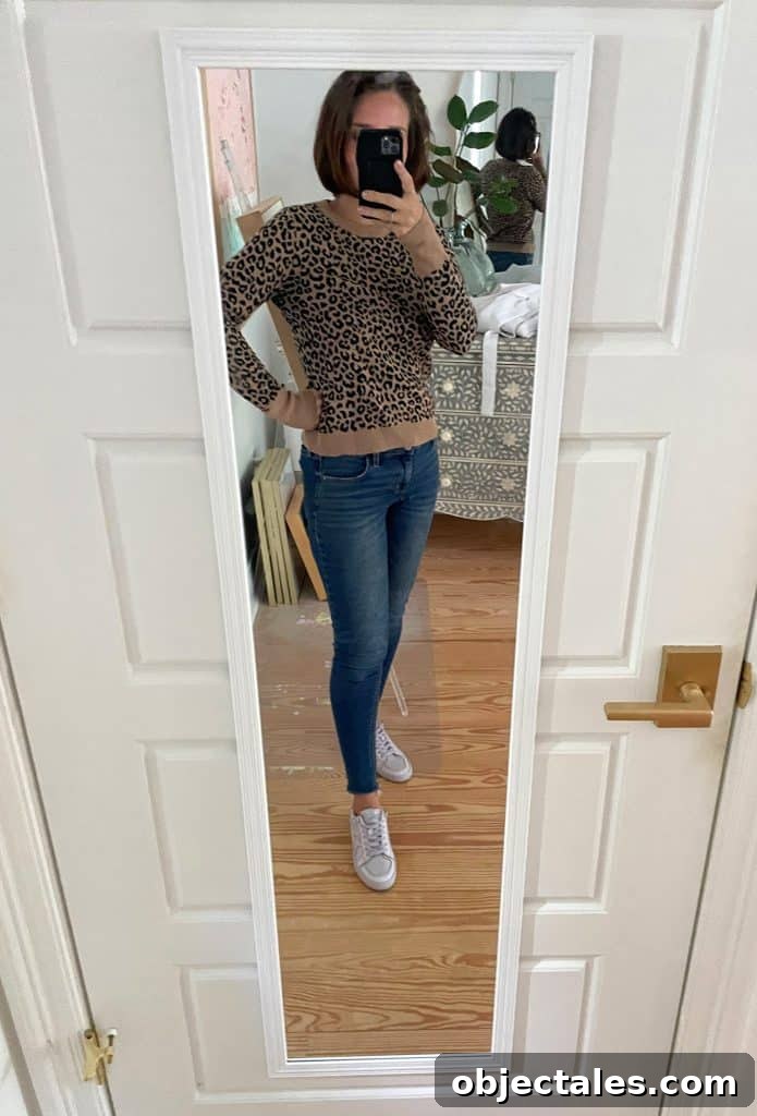 Sherry selfie in mirror at home with leopard sweater and jeans