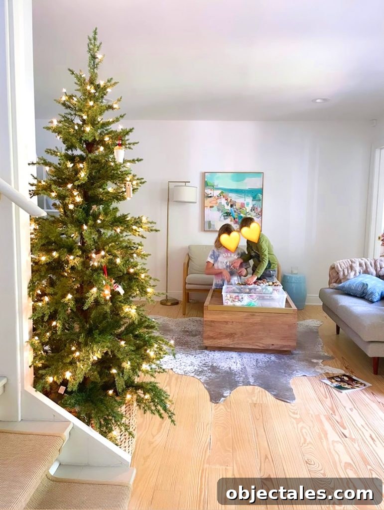 Christmas Tree undecorated in kitchen with children grabbing ornaments in background
