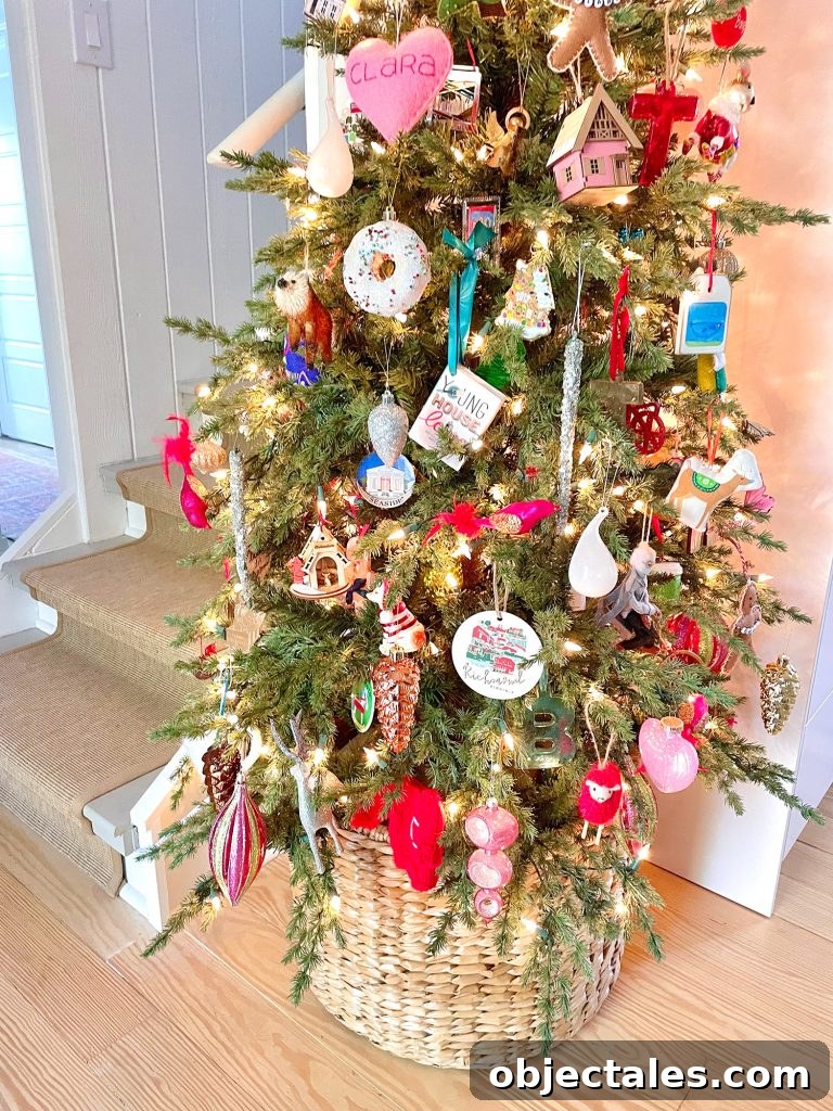 Detail of ornaments on narrow Christmas tree in kitchen in wicker basket