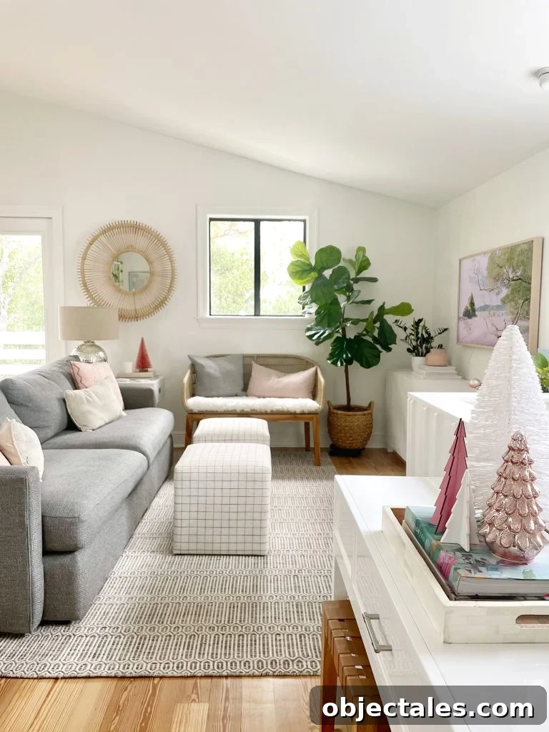 Wide view of living room with new sheepskin loveseat and decorative Christmas trees on tabletop