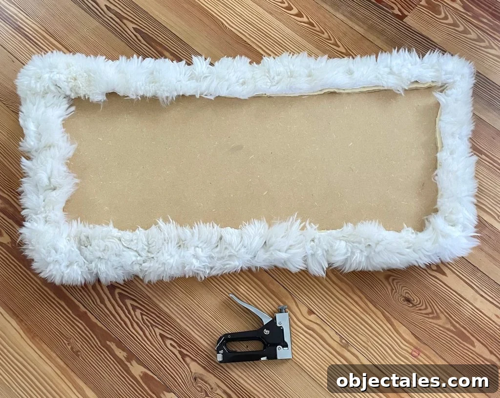 Backside of loveseat seat upholstered with sheepskin rug