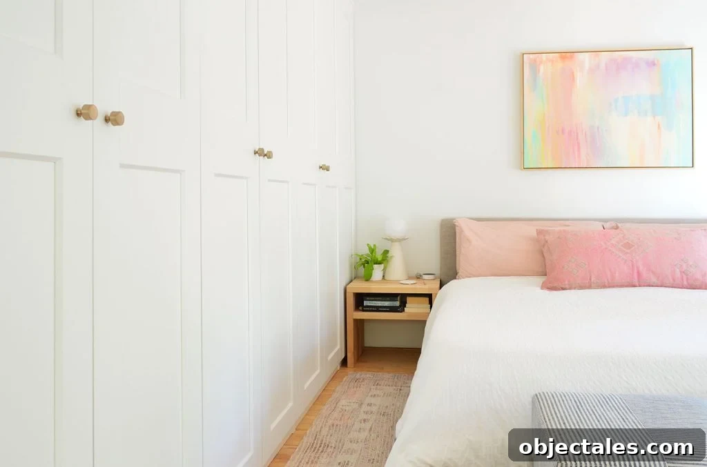 Wall Of Ikea Pax Wardrobes Next to King Size Bed With Colorful Painting