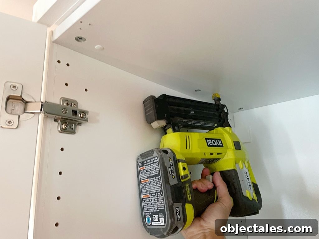 Nailing Backer Piece To Top Of Ikea Wardrobe Using Nail Gun
