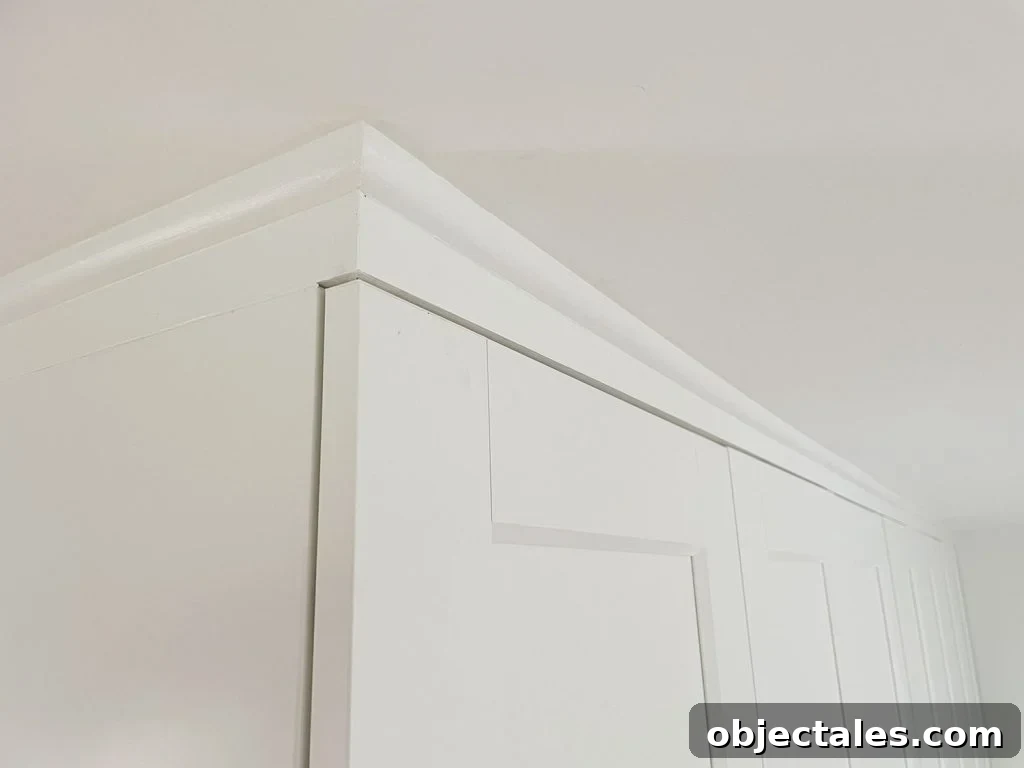 Finished and painted quarter round molding that makes Ikea Pax Wardrobes look built in