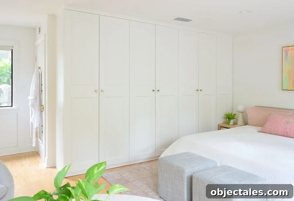 Row of Ikea Pax Wardrobe Closets In Bedrom With Gold Knobs