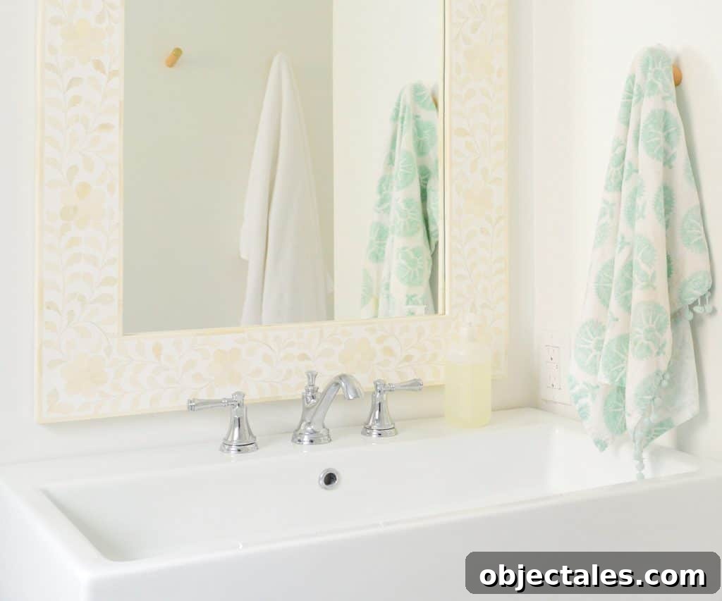 Bright modern bathroom with large white sink and bone inlay mirror