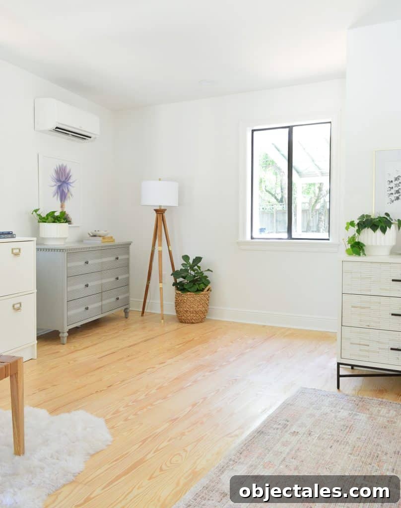 Before photo of corner of bedroom after moving in with random dressers and lamps