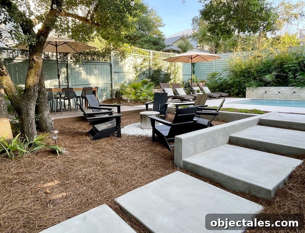 Concrete Steps Leading Up To Pool In Backyard With Firepit