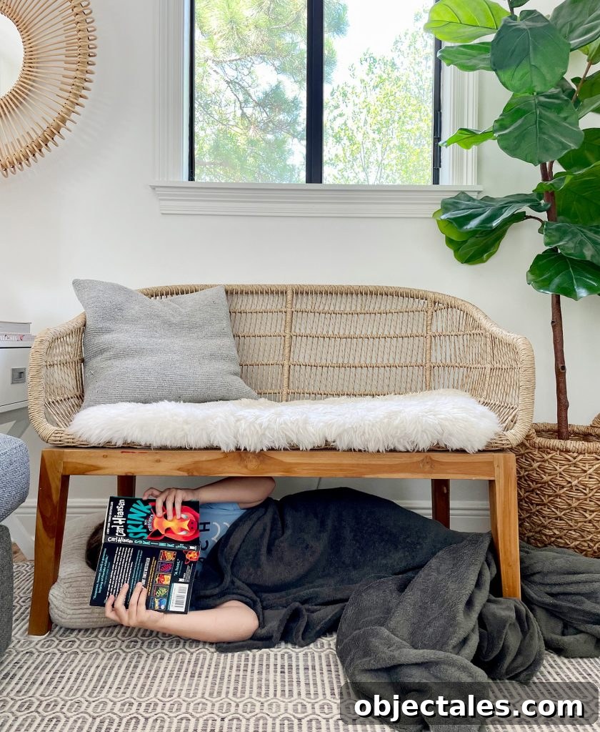 Kid Reading Under A Bench In Living Room With Blanket