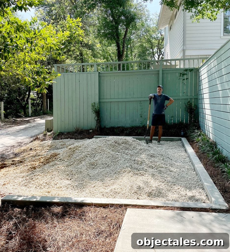 Poured Concrete Walkways and Driveway Installation Guide 11 John with shovel spreading pile of bahama rock in driveway parking spot