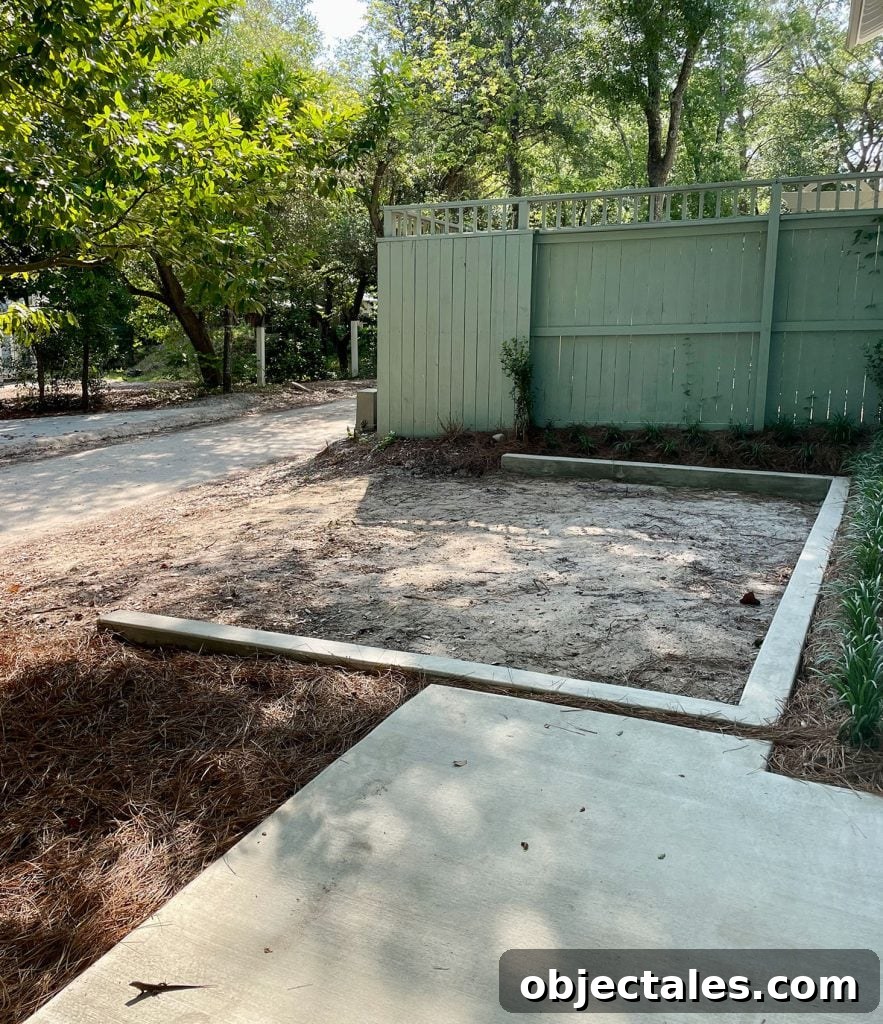Poured Concrete Walkways and Driveway Installation Guide 9 Concrete wall designating parking space by fence