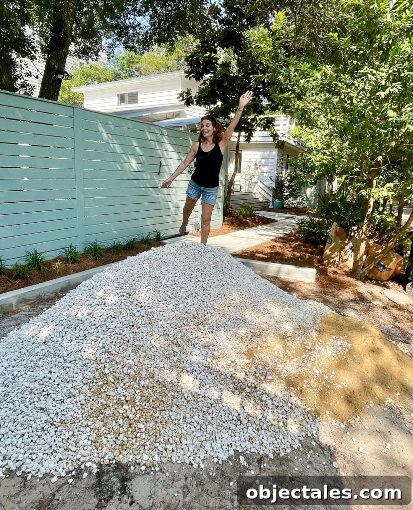 Poured Concrete Walkways and Driveway Installation Guide 10 Sherry standing on top of freshly delivered pile of bahama rock gravel for driveway
