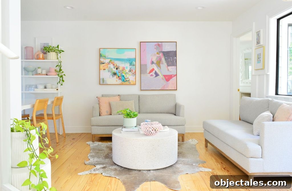 White Kitchen Sitting Area With Two Loveseats And Colorful Artwork