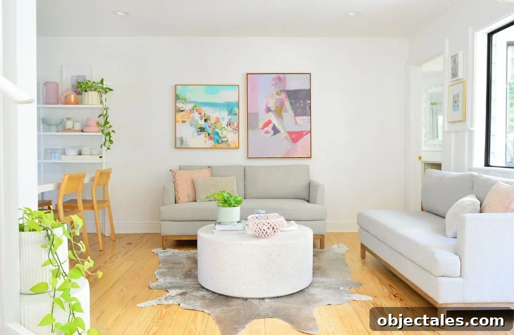 White Kitchen Sitting Area With Two Loveseats And Colorful Artwork