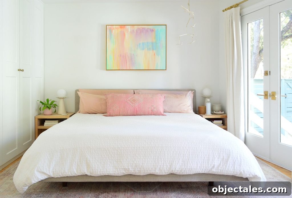 6 Bedroom Upgrades That Transformed Our Space 10 White King Bed With Pink Pillows And Bright Colorful Painting