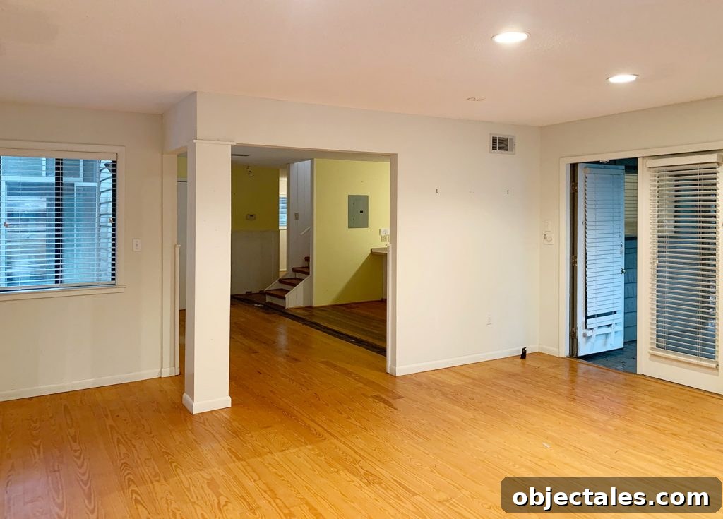 6 Bedroom Upgrades That Transformed Our Space 7 Before photo of living room turned bedroom with open wall to kitchen