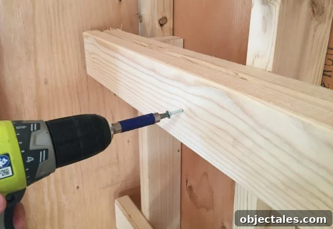 Build Sturdy DIY Garage Shelving: Step-by-Step Plans 6 screwing in horizontal support for DIY garage shelf