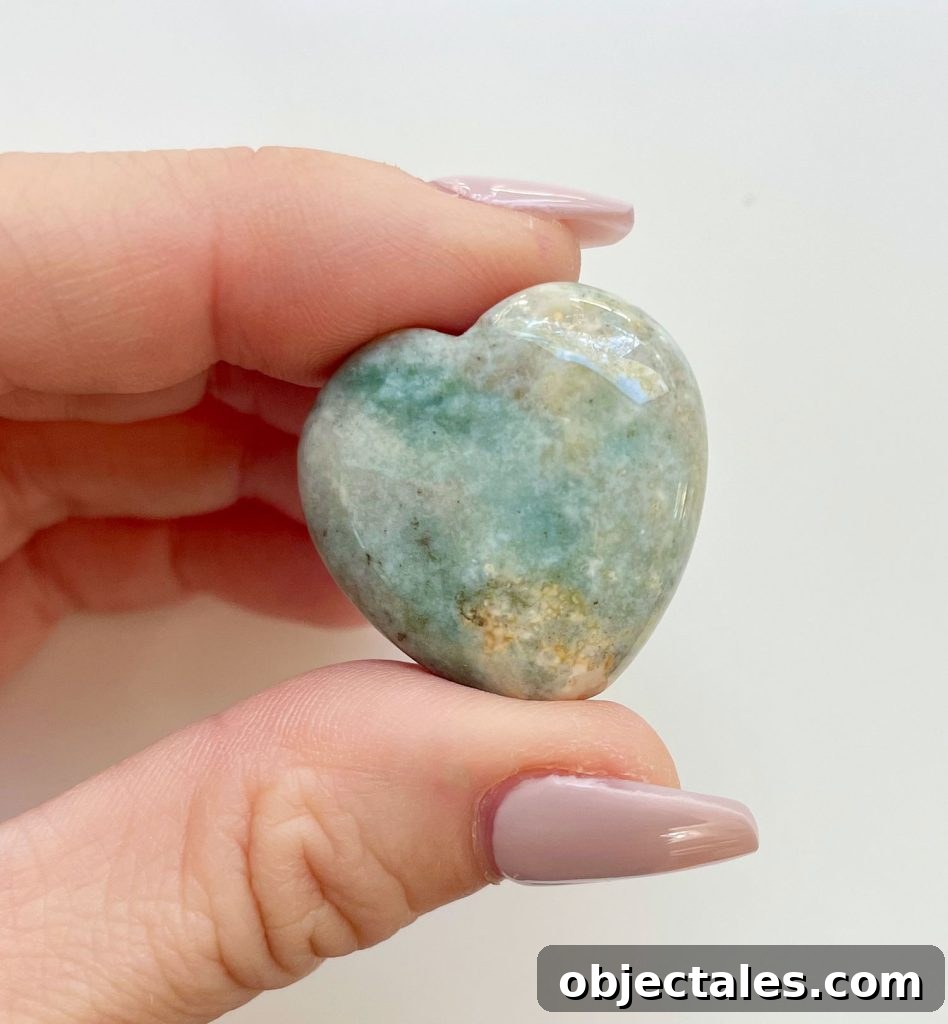 Ocean Jasper Crystal Heart Between Fingertips