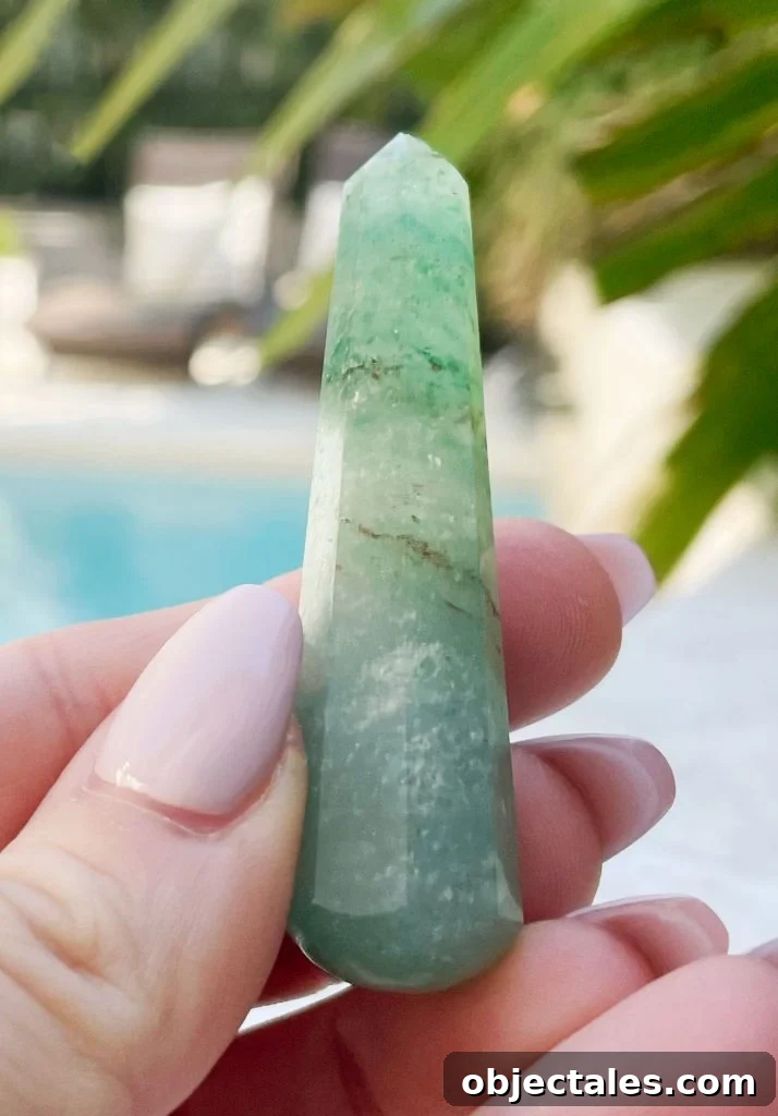 Green Aventurine Crystal: Meaning, Properties and Uses 3 Hand holding green aventurine crystal point
