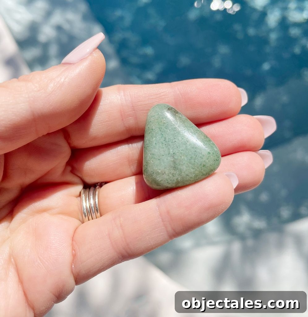 Green Aventurine Crystal: Meaning, Properties and Uses 4 Hand holding green aventurine polished gemstone over water
