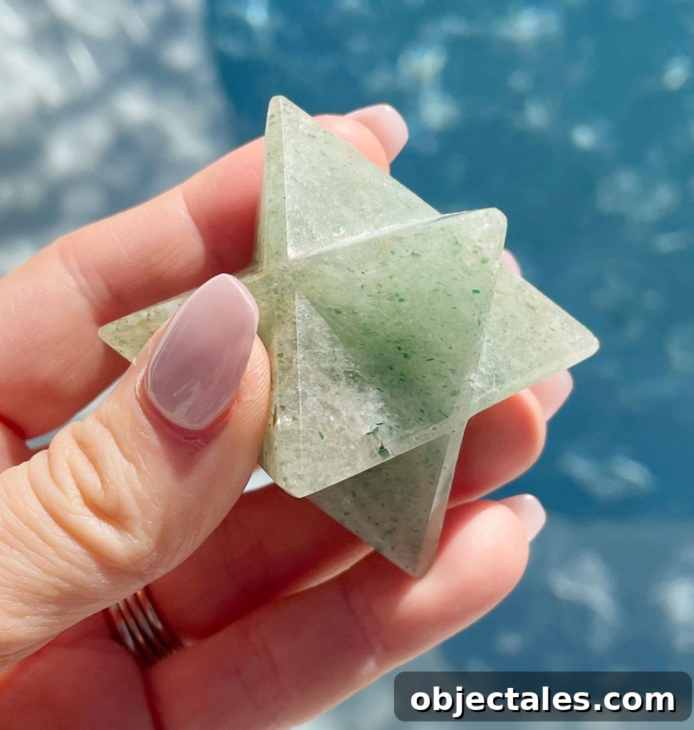 Green Aventurine Crystal: Meaning, Properties and Uses 7 Hand holding green aventurine merkaba asteroid over water