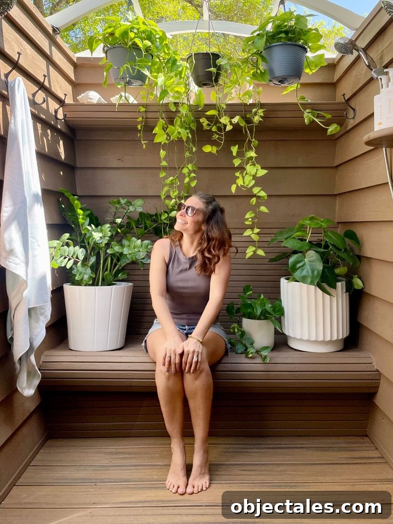 How We Used Solid Stain on Our Outdoor Shower 11 Sherry Sitting In Outdoor Shower With Plants and Behr Solid Stain Walls Tugboat