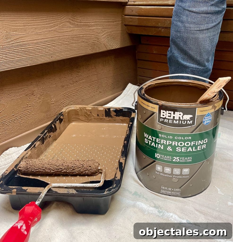 How We Used Solid Stain on Our Outdoor Shower 3 Can Of Behr Premium Solid Color Stain In Tugboat Next To Roller Tray