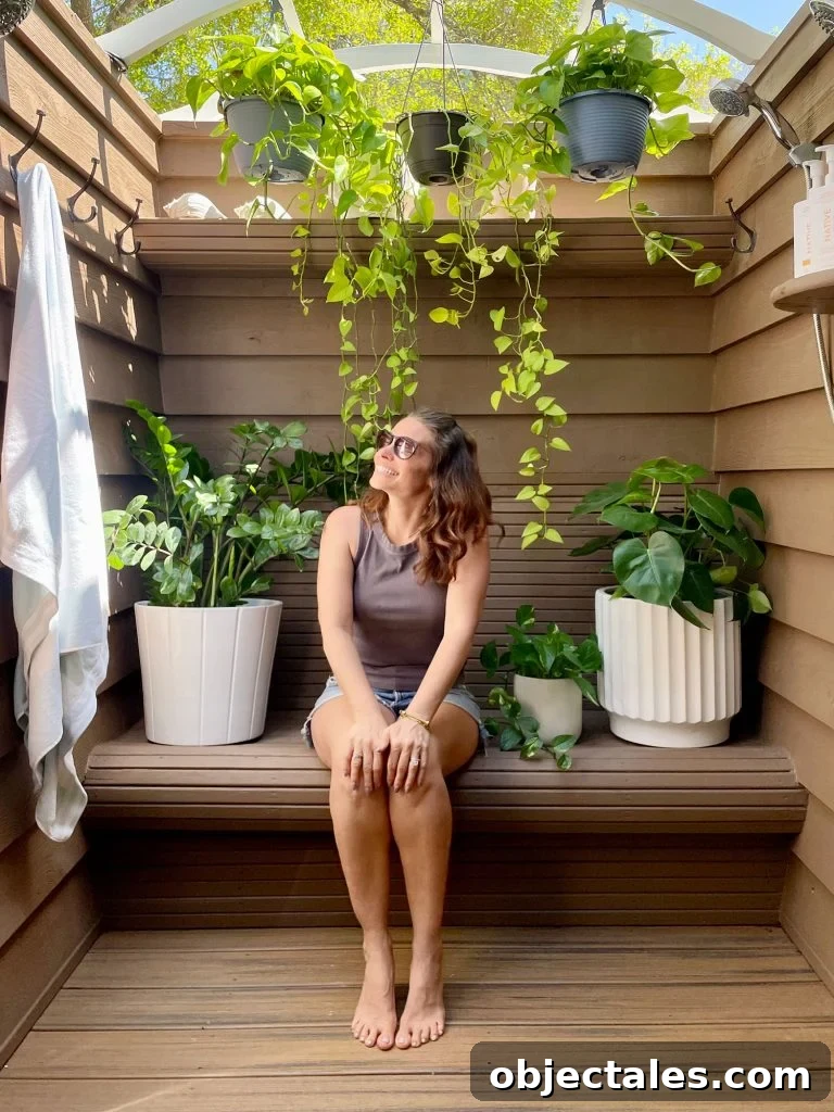 How We Used Solid Stain on Our Outdoor Shower 21 Sherry Sitting In Outdoor Shower With Plants and Behr Solid Stain Walls Tugboat