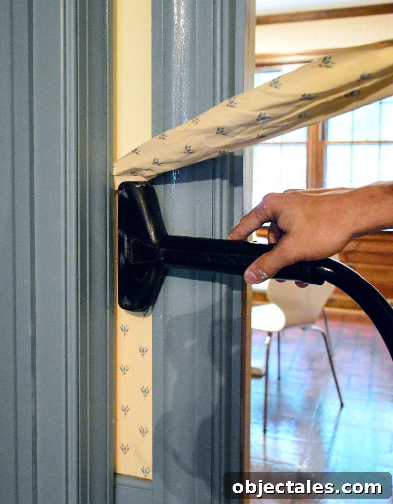 How to Remove Wallpaper Without Damaging Walls 11 Close Up Of Steamer Against Wallpaper