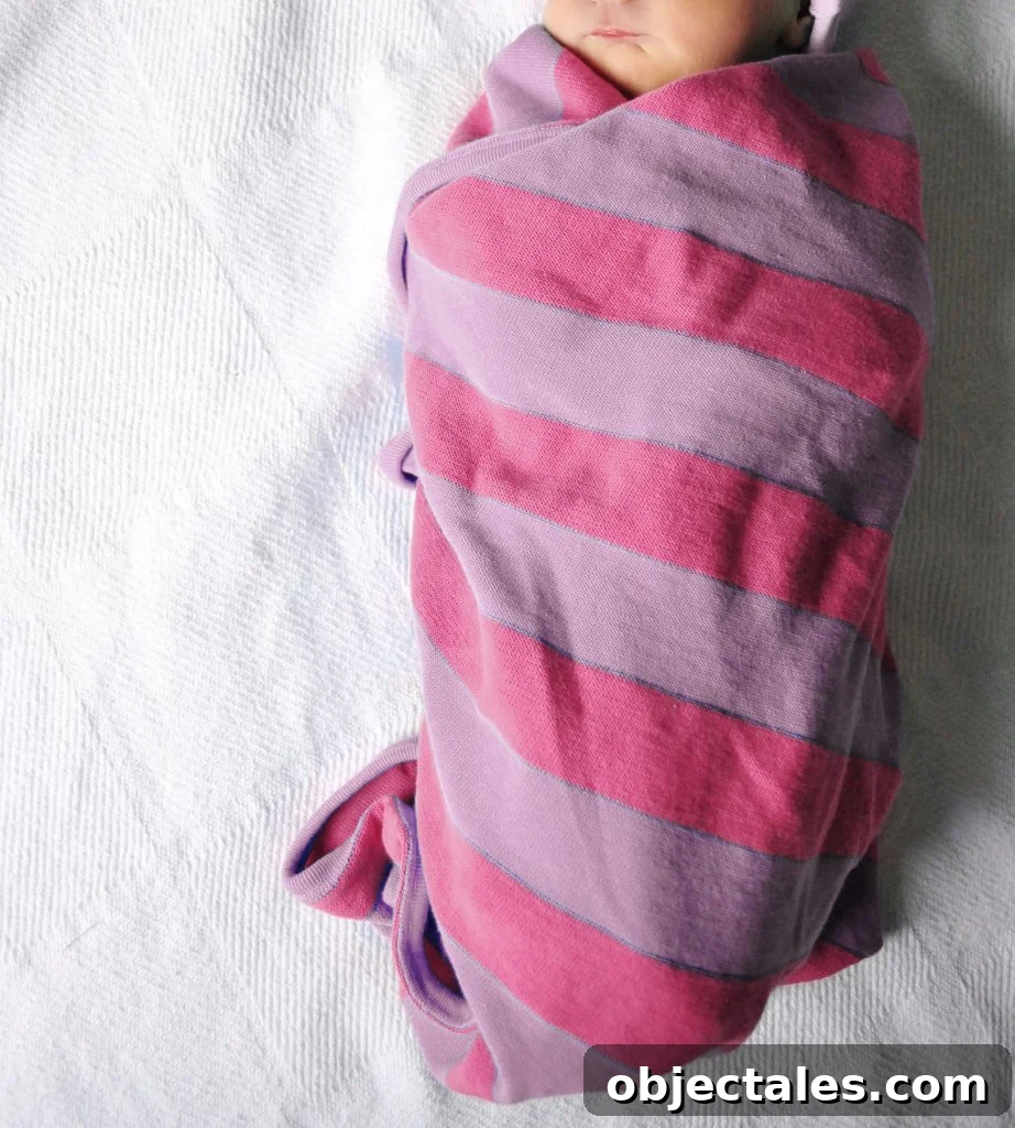 Newborn Baby Girl Swaddled In Pink Purple Striped Blanket