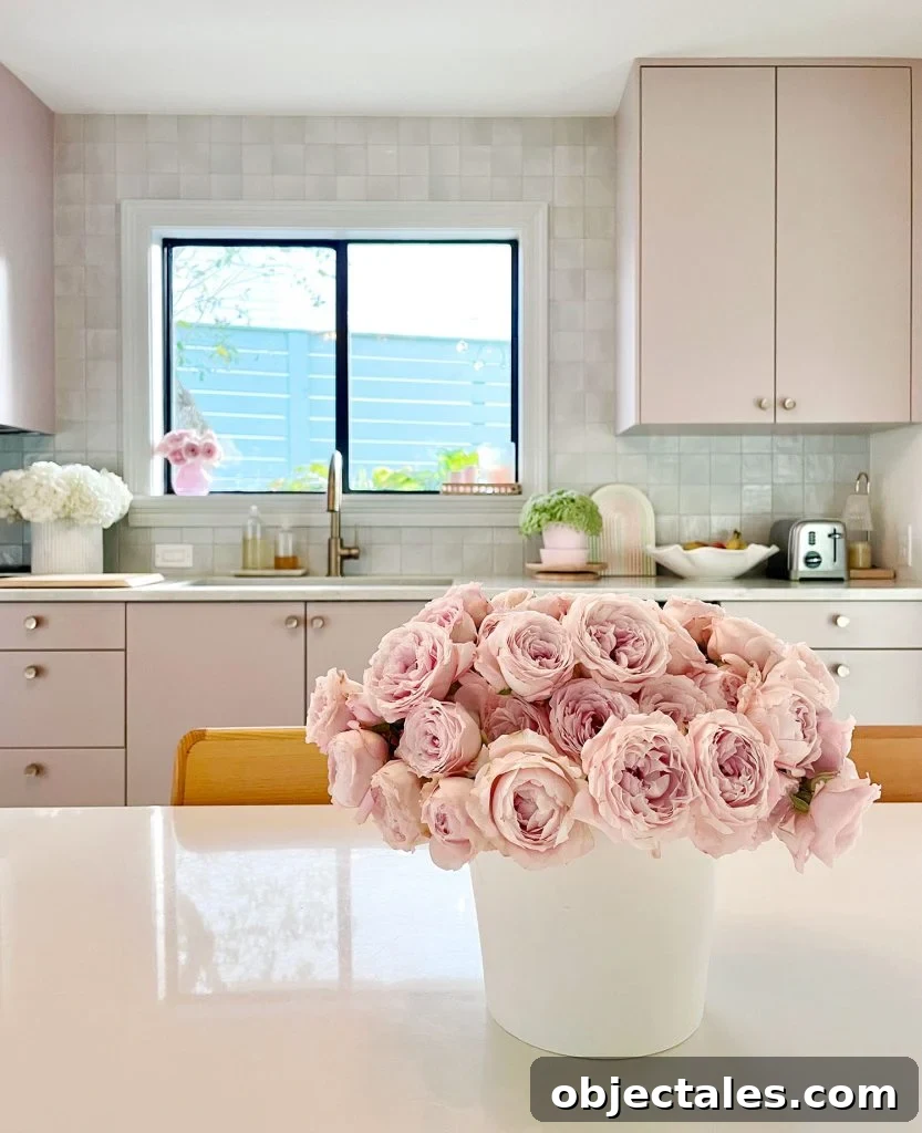 Pink Roses On Breakfast Table In Kitchen With Mauve Cabinets And Tile Backsplash