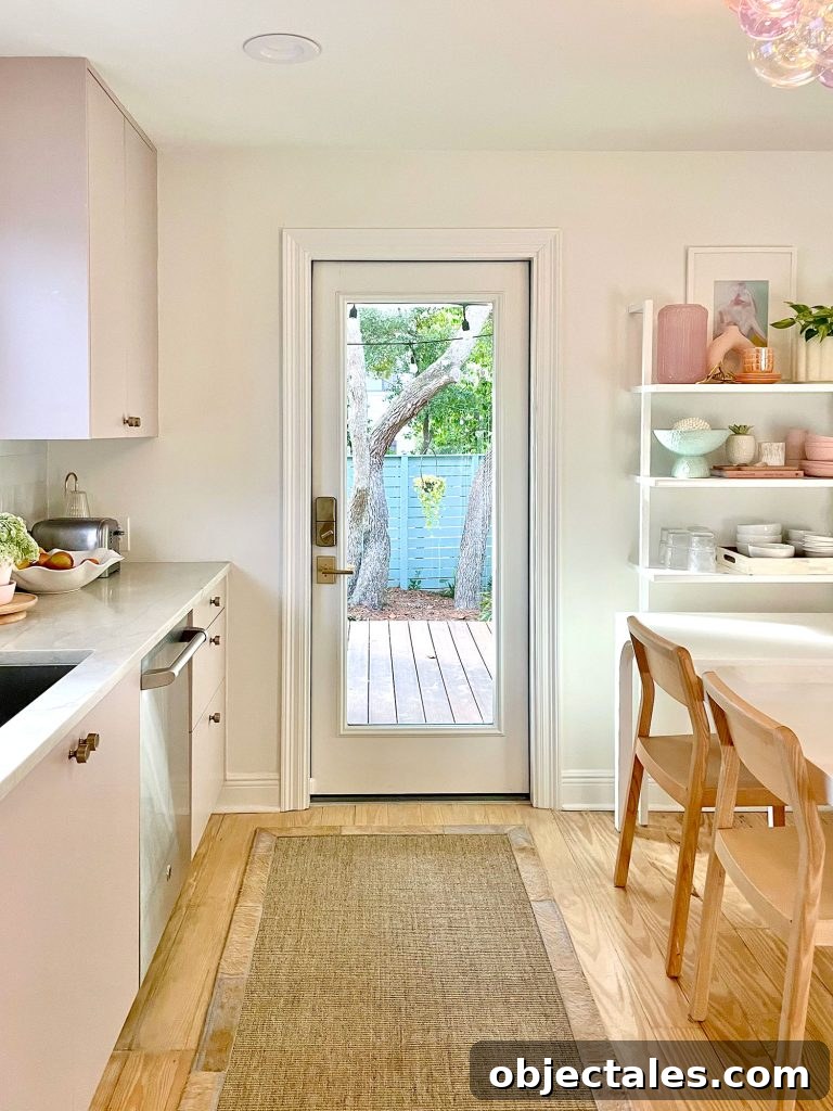 Small Kitchen With Mauve Cabinets And Doorway To Porch