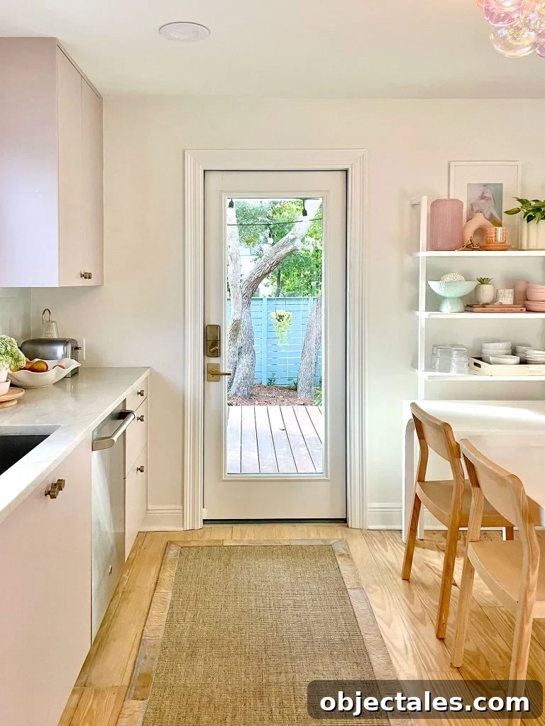 Small Kitchen With Mauve Cabinets And Doorway To Porch
