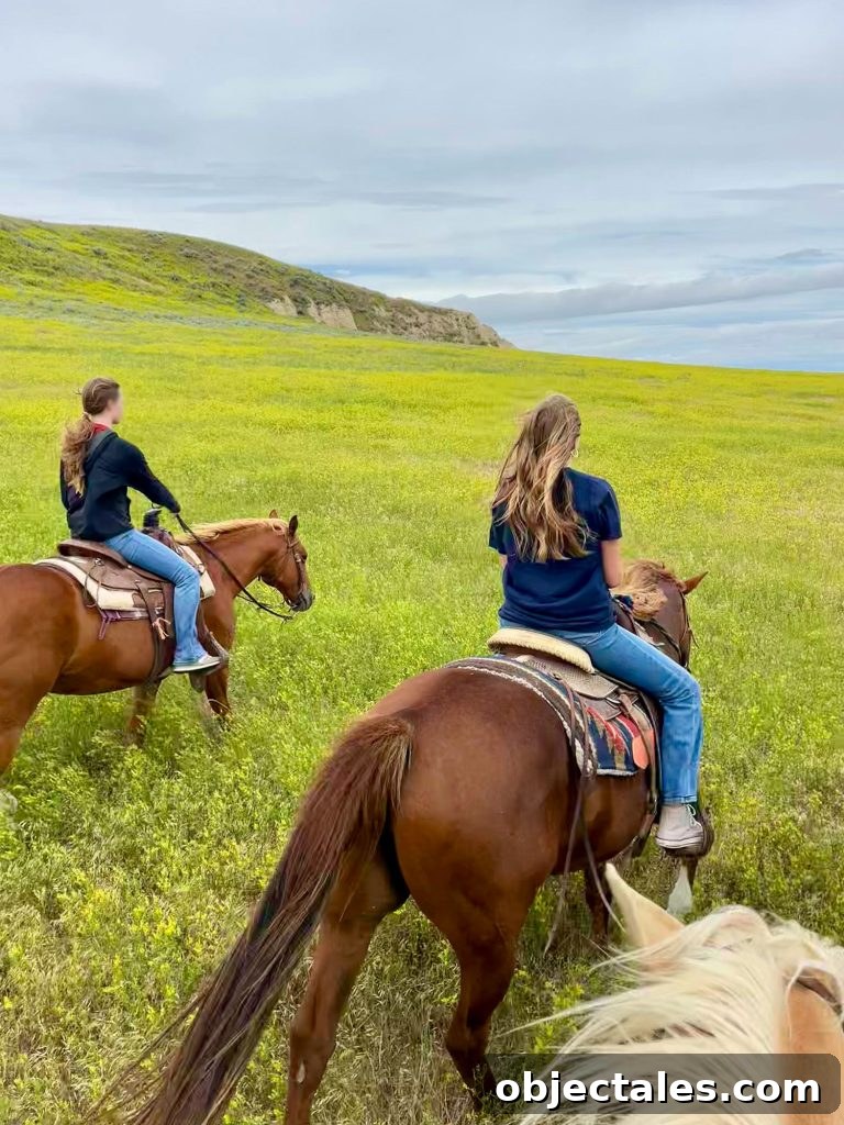Two Girls Horseback Riding In Badlands South Dakota Among Sweet Clover