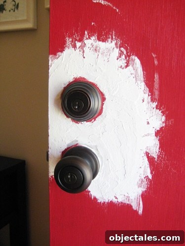 Upgrade Front Door Hardware: Modernize Locks, Handles & Hinges 4 Applying spackle to door
