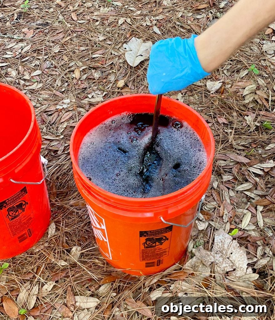 How to Dye Clothes at Home: Step-by-Step Tutorial 11 Hand Stirring Bucket Of Black Rit Fabric Dye With Clothes Inside
