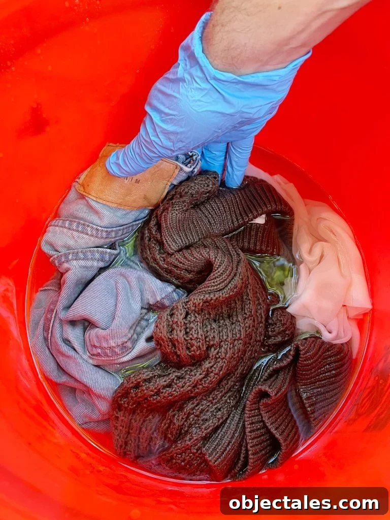 How to Dye Clothes at Home: Step-by-Step Tutorial 7 Pre-wetting clothes to be dyed in bucket