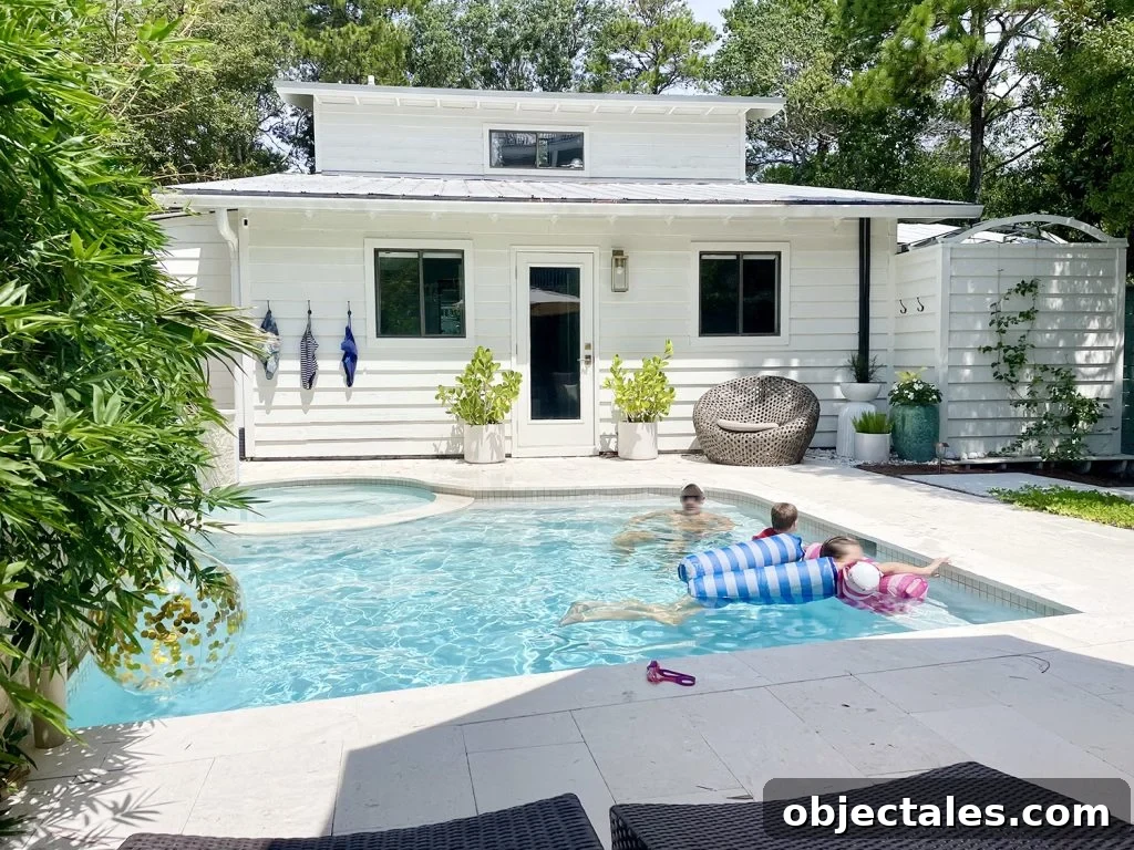 John and kids swimming in backyard pool