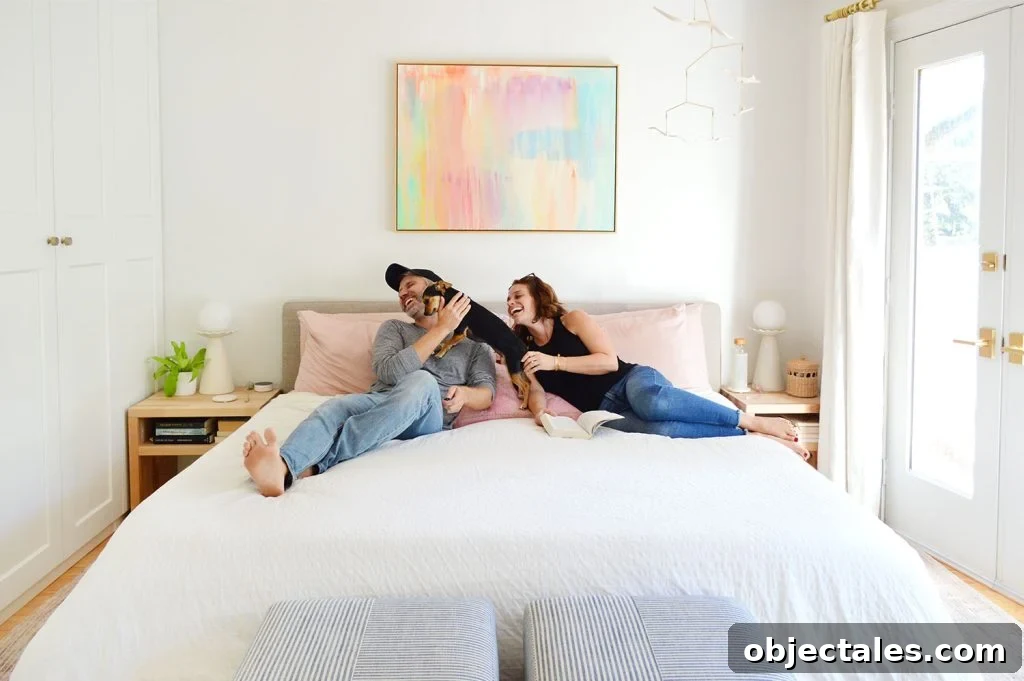 Dog Making John And Sherry Laugh On King Size Bed With White Bedding