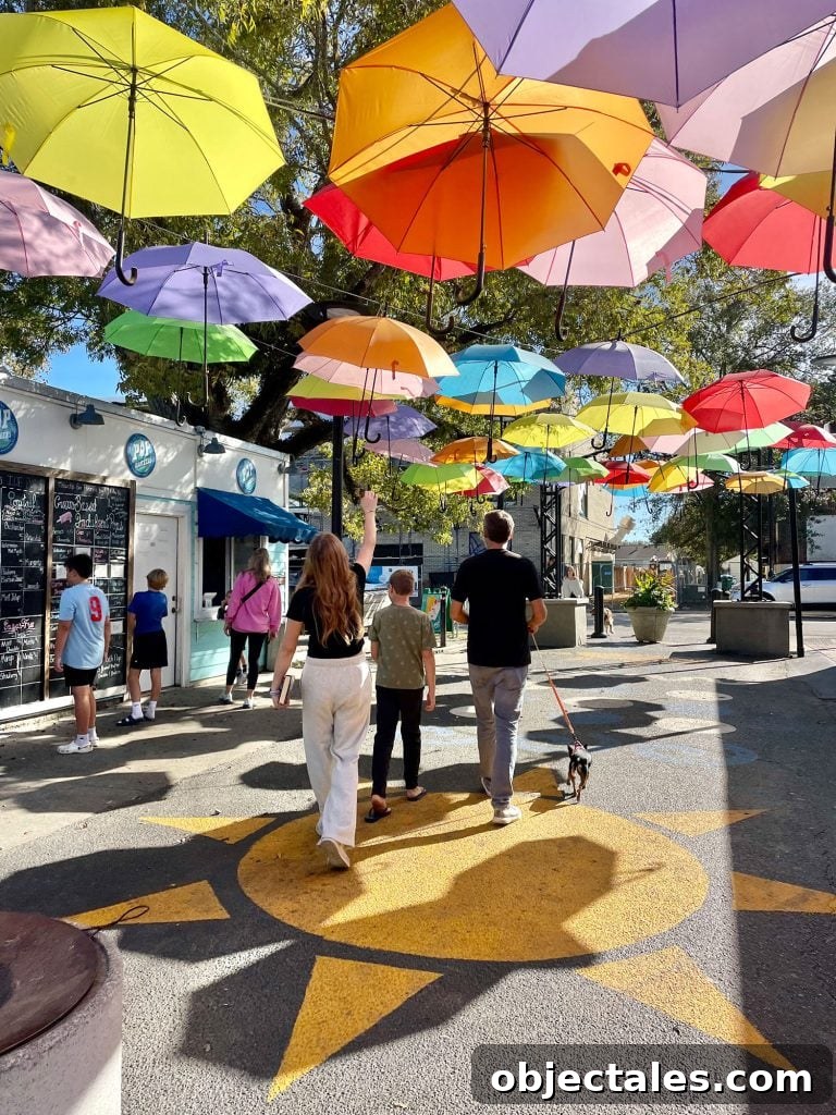Weekend Escape in Ocean Springs: Beaches, Art and Dining 2 Kids Walking Under Bright Umbrellas In Cash Alley In Ocean Springs Mississippi