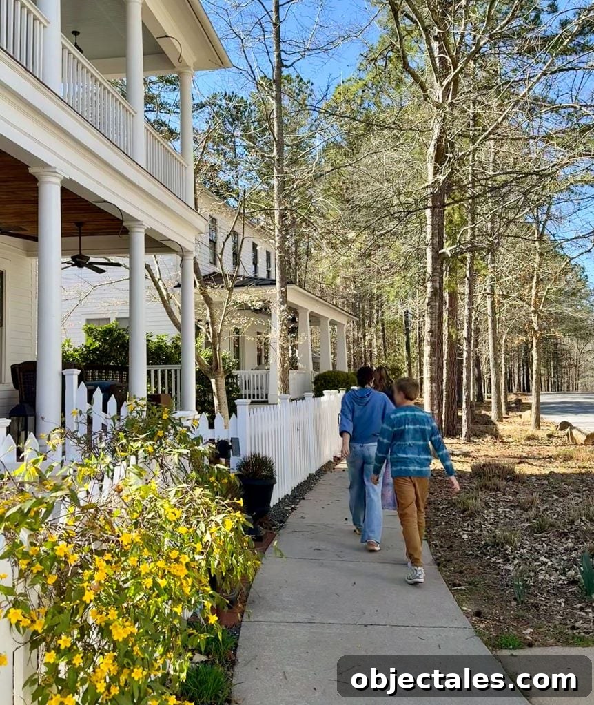 Family Walking Past Homes In Serenbe Georgia