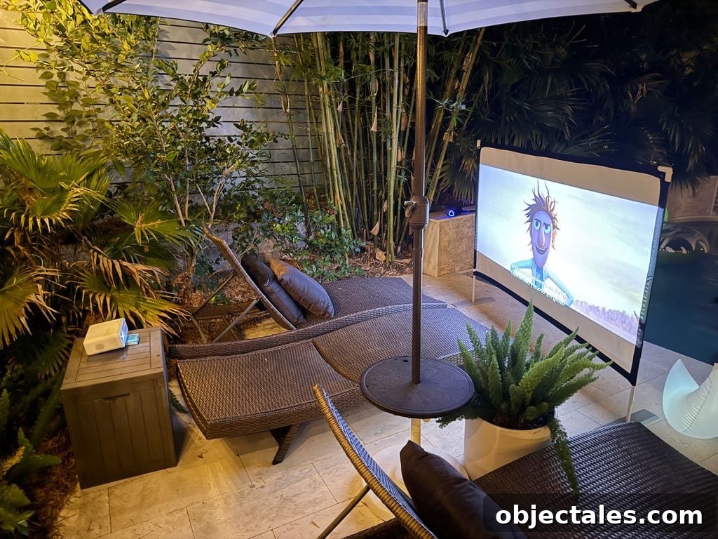 Host an Outdoor Movie Night: Gear Under $200 16 Projector Set Up Behind Outdoor Movie Screen