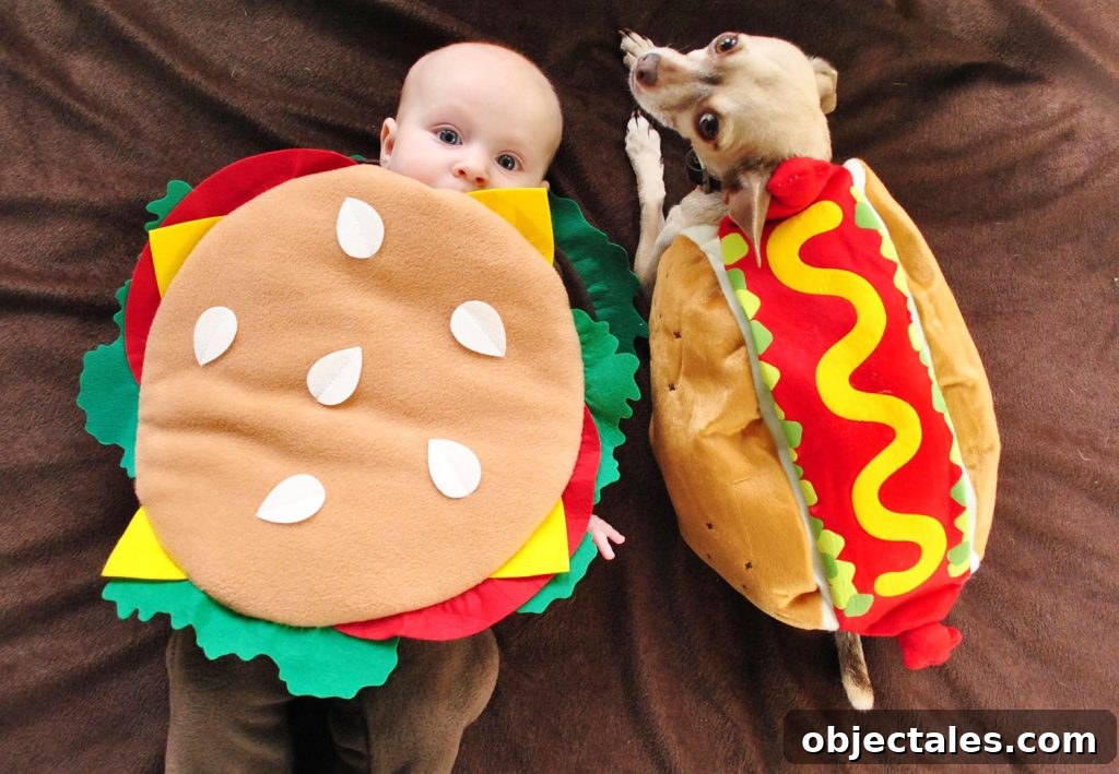 Baby Dressed as Hamburger Next to Dog In Hot Dog Costume