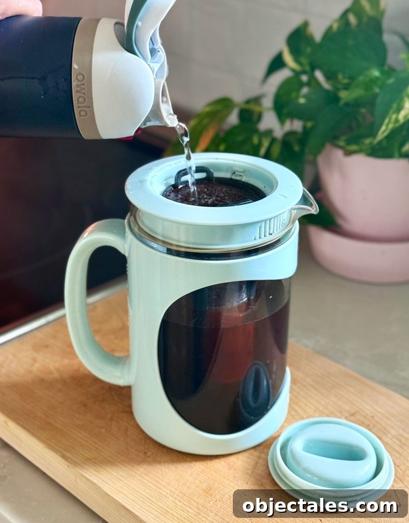Make Smooth Cold Brew Coffee at Home 8 Adding Water Over Coffee Grounds In Home Cold Brew Maker