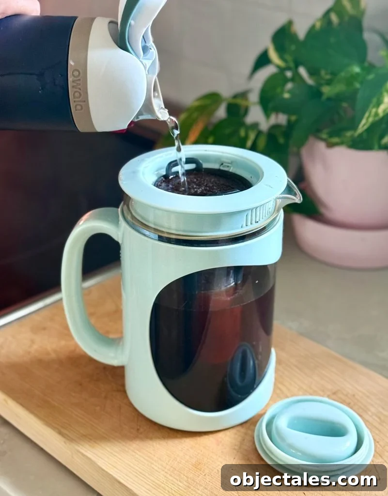 Adding Water Over Coffee Grounds In Home Cold Brew Maker