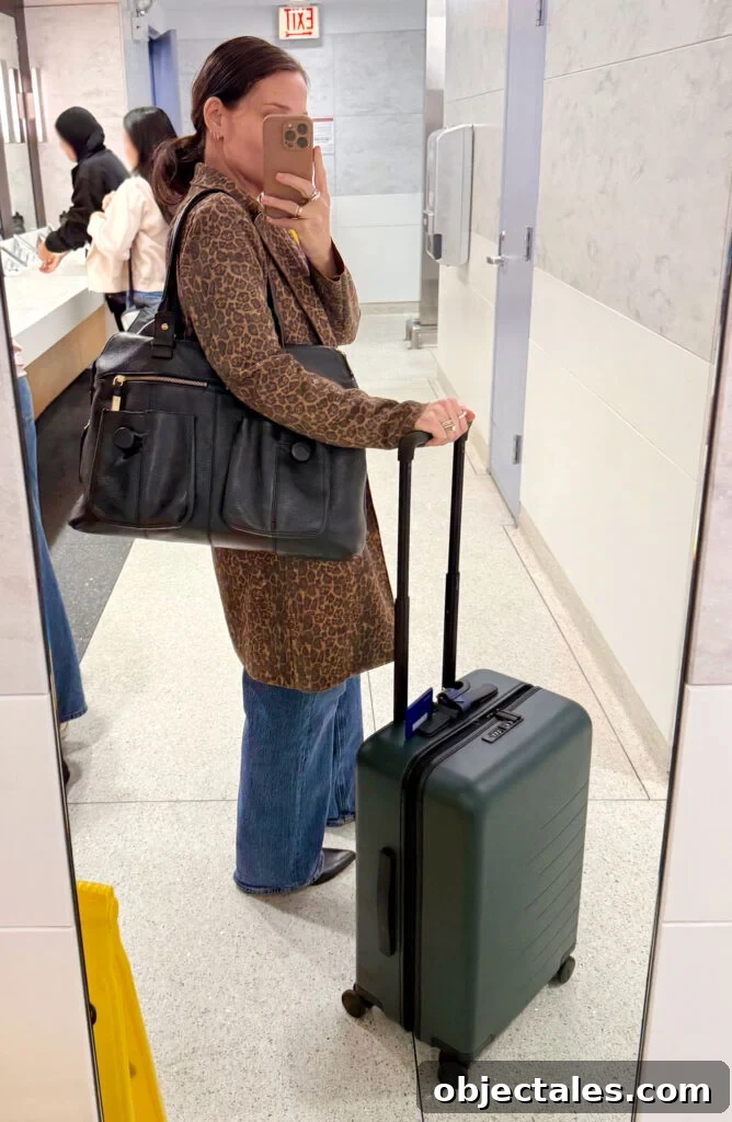 How I Packed One Carry-On for Two Weeks in Italy 3 Sherry Selfie In Airport Mirror With Suitcase On Trip To Italy