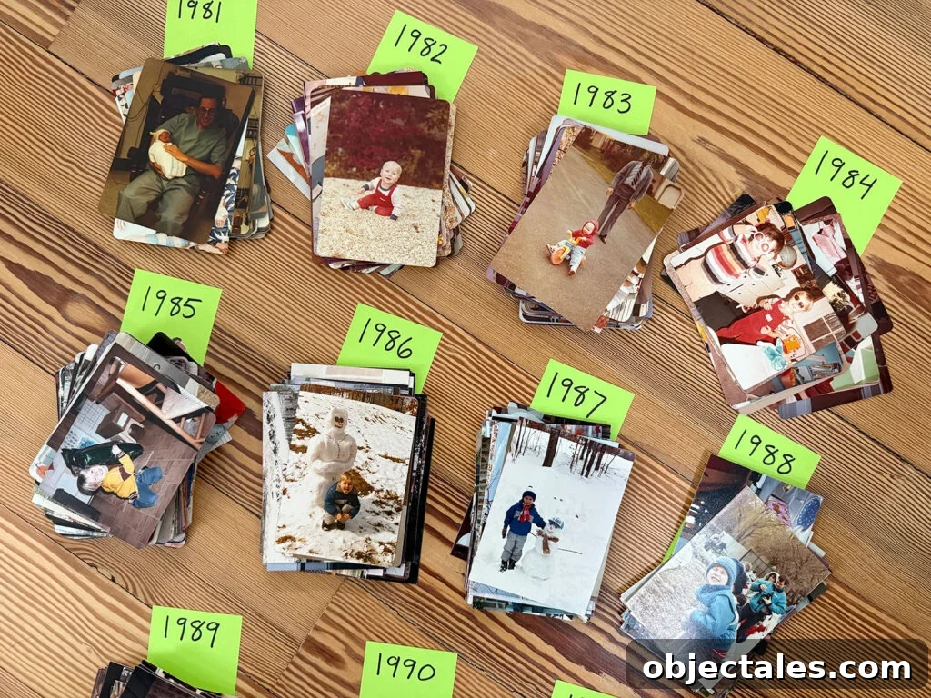 How We Organize Our Digitized Photo Library 9 Stacks of Old Photos Sorted By Year