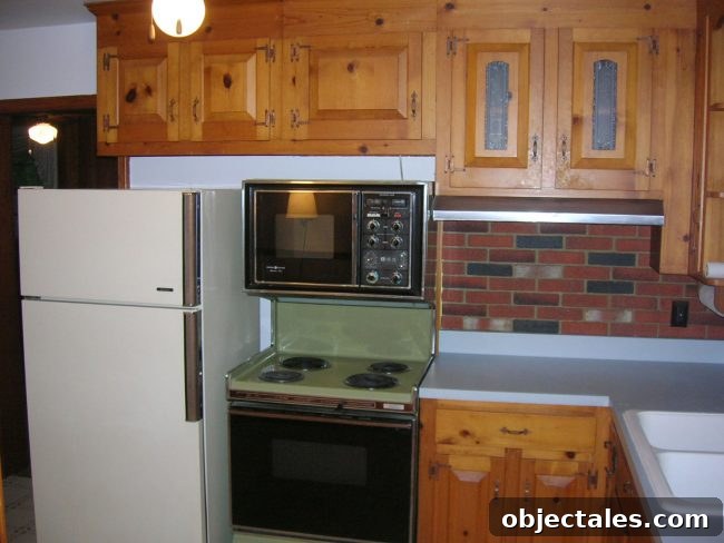 Original 1970s kitchen with heavy wood paneling and dated finishes