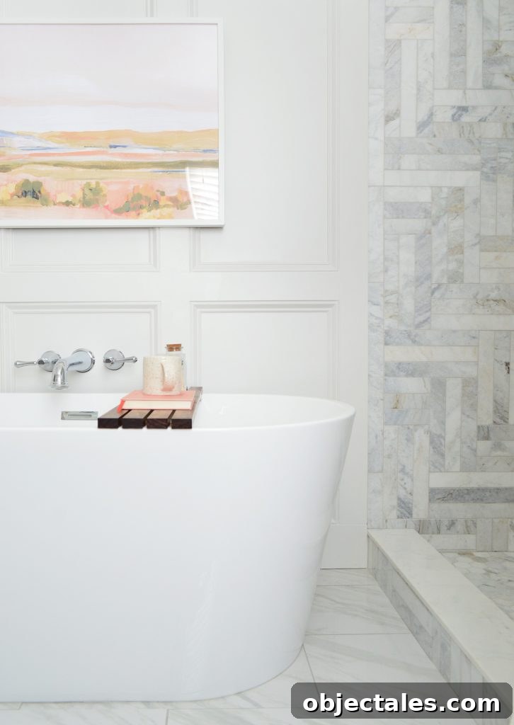 Freestanding tub side view in modern bathroom with marble shower